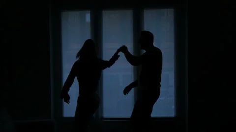 Young couple dancing at home by window, slow motion shot Stock Footage 115261729