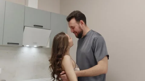 Young couple dancing in kitchen, playful romantic mood Stock Footage 327927938