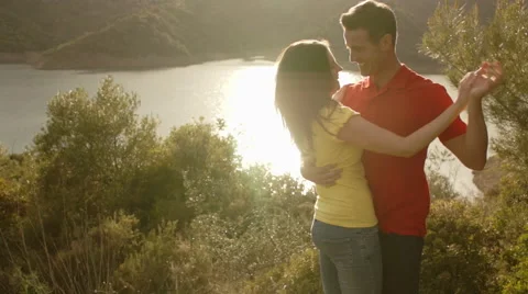 Young couple dancing by lake. Stock Footage 43667265