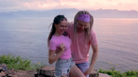 Young couple dancing modern dance by the sea Video stock 237301764