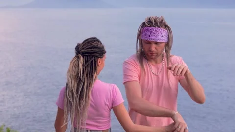 Young couple dancing modern dance by the sea Video stock 237302110
