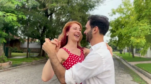 Young couple dancing outdoors Stock Footage 303828918