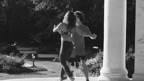 Young couple dancing on the square Stock Footage