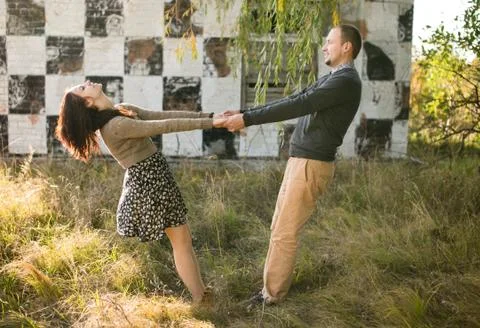 Young couple dancing at sunset Stock Photos