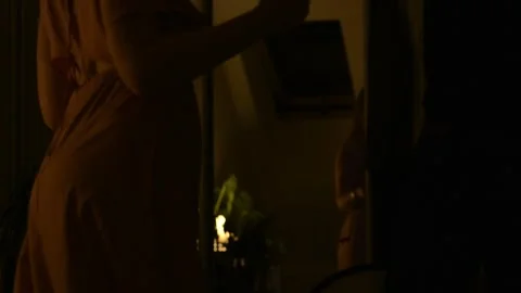 Young couple dancing together in a dimly lit room during the evening. Stock Footage 330800632