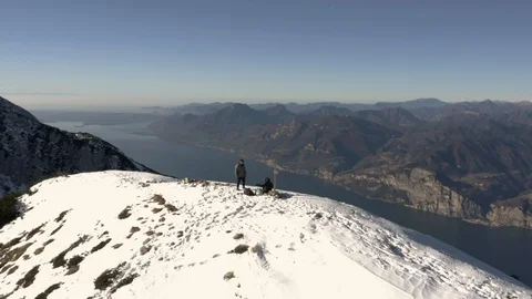 Young couple dancing on top of snow covered mountain, Lake Garda Stock Footage 102496130