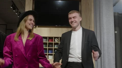 Young couple dancing while shopping formalwear in clothing store Stock Footage 297471162