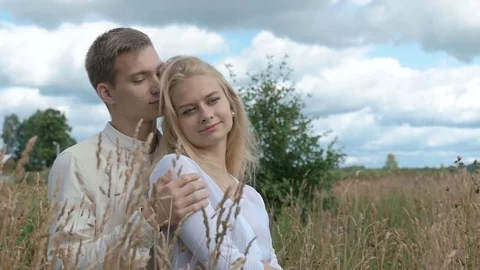 Young couple on date in wheat field. slow motion Video stock 79985040