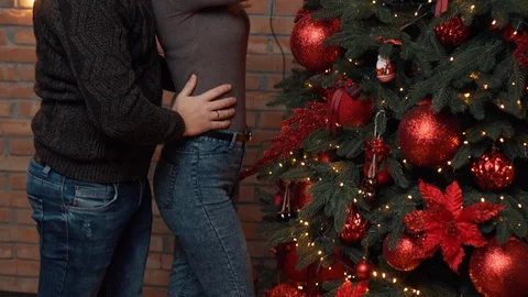Young couple decorating christmas tree together at home Stock Footage 120465264
