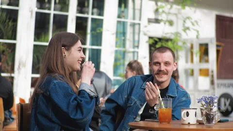 Young couple Denim clothes date in a vintage restaurant, outside They are Stock Footage 251702304