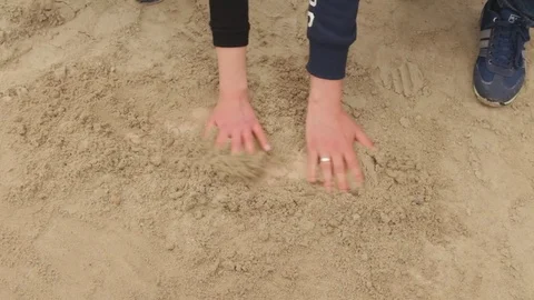 Young couple deploys sand by their hands Stock Footage 71949500
