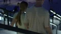 Young couple descending stairs on romantic evening date at city shopping mall HD Footage