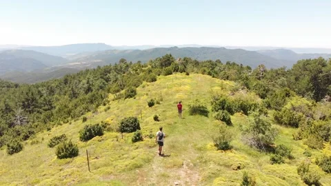 Young couple descends a mountain path with beautiful scenery 動画素材 144521635