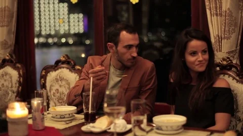 Young couple dining in a romantic atmosphere at restaurant on the boat Stock Footage 73632154