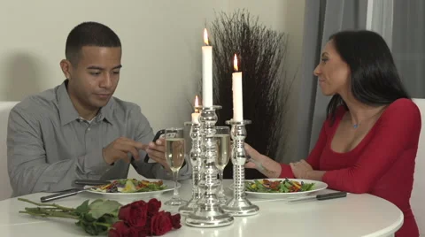 Young couple at dinner table with smartphone Stock Footage 44113745
