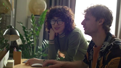 Young Couple Discussing Programming Code on Computer Screen at Home Stock Footage 306460326