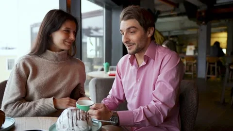 A young couple is discussing something in a cafe Stock Footage 167946147