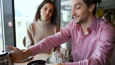 A young couple is discussing something in a cafe Stock Footage 168097609