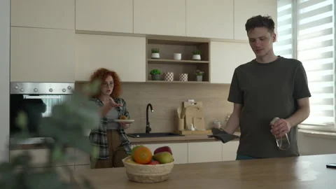 Young couple discussing while cleaning the kitchen counter top Stock Footage 333262061