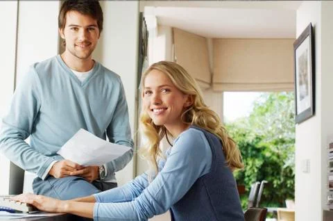 Young Couple With Documents And Computer Stock Photos