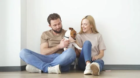 Young Couple With Dog At Home, Having Fun, Enjoy Spending Time Together. Video stock 156541553