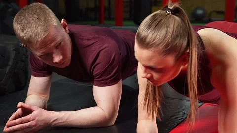 Young couple doing exercise in the gym Stock Footage 101290667