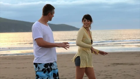 Young couple doing a hula on the beach together. Video stock 88406648