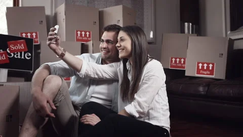 Young couple doing selfie or self portrait for memories in there new apartment Video stock 199631277