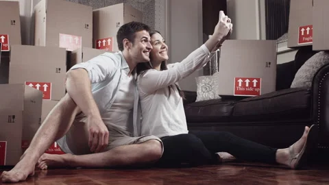 Young couple doing selfie or self portrait for memories in there new apartment Vídeo Stock 199631691
