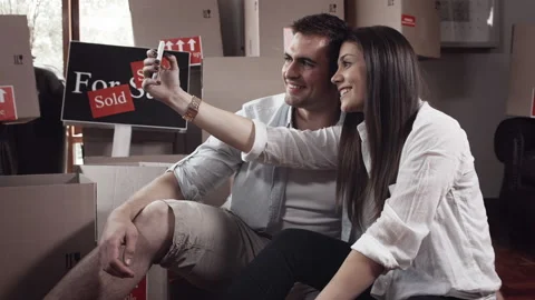 Young couple doing selfie or self portrait for memories in there new apartment Stock Footage 199631692
