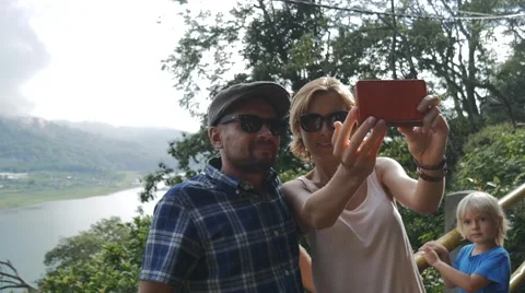 Young couple doing selfie on smart phone on the beautiful landscape background Stock Footage 68030456