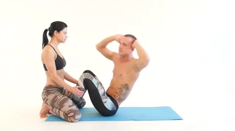 Young Couple Doing Sit-Ups Stock Footage 60005087