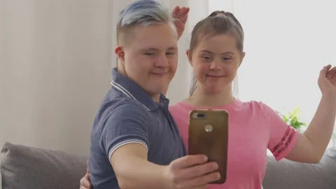 Young couple with Down Syndrome taking a selfie Stock Footage 149836807