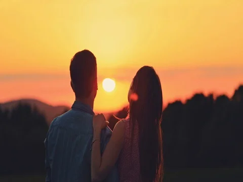 Young Couple Dream about the Future at Sunset, Silhouette. SLOW MOTION 4K. Vidéo 77816730