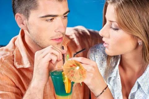 Young couple drinking cocktail Stock Photos