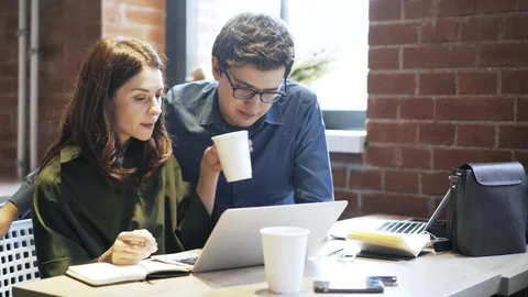 Young couple drinking coffee and studying in a cafe 스톡 동영상 76274731
