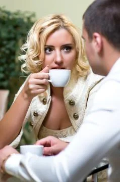 Young couple drinking coffee in a restaurant Stock Photos
