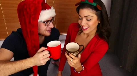 Young couple drinking hot drinks. Christmas time. 50 fps. Stock Footage 57369123