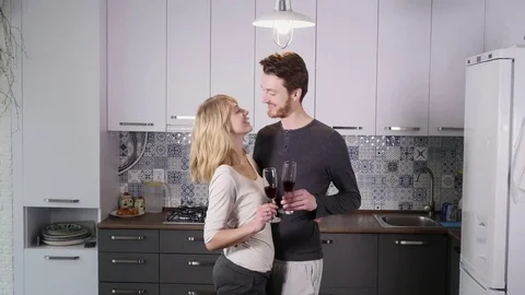 Young couple drinking red wine in the kitchen at home Stock Footage 74511365