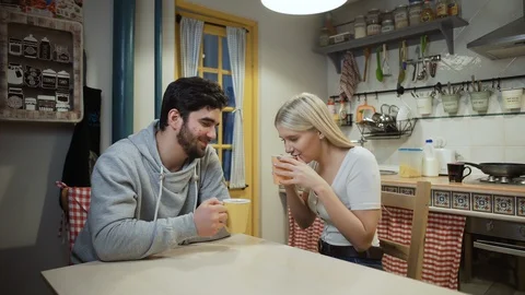 Young couple drinking tea together on a kitchen Video stock 128248330