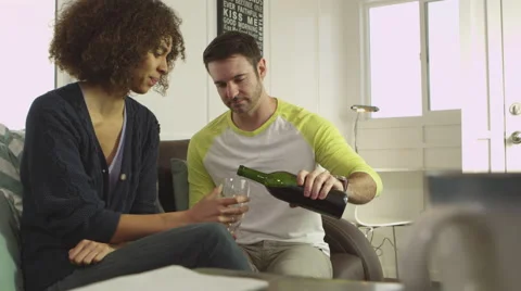 Young couple drinking wine and chatting on sofa Stock-Footage 67355622