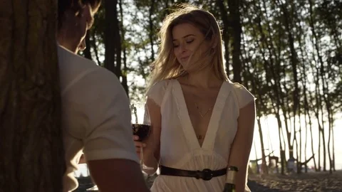 A young couple drinking wine on a beach Video stock 76222803