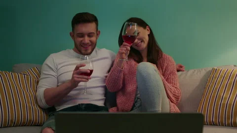 Young Couple Is Drinking Wine during Video Call 스톡 동영상 145490133