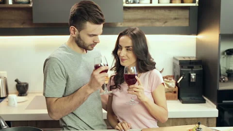 Young couple drinking wine at the kitchen. Stock Footage 100303302
