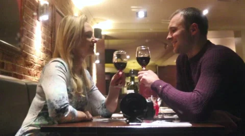 Young couple drinking wine in a restaurant Stock Footage 48220693