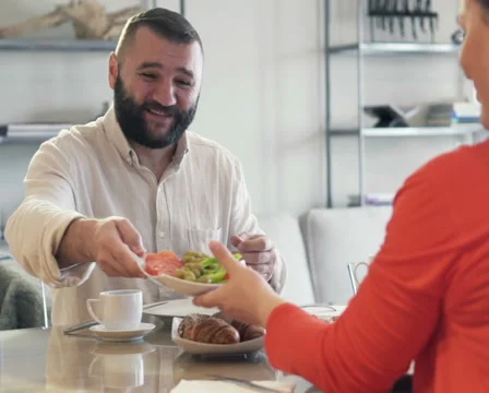 Young couple during breakfast by table at home PAL Stock Footage 57538077