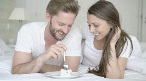 Young couple eating pie in bed Stock Footage 62684810