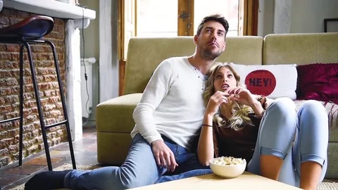 Young couple eating popcorn while watching movie. Stock Footage 74728582