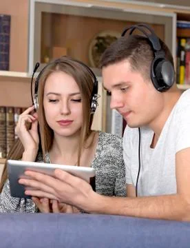 Young couple with electronic device Stock Photos