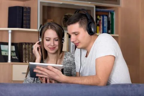 Young couple with electronic device Stock Photos